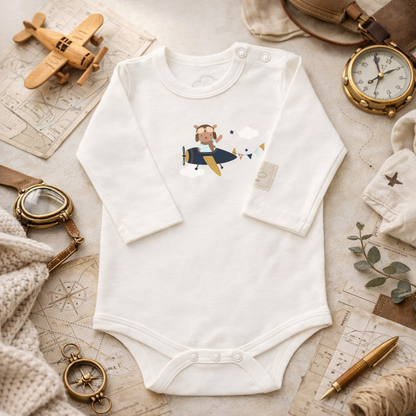 White baby bodysuit with TEDDY PILOT graphic, lifestyle view – Kumy Kids