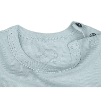 Close-up of a light gray baby outfit with a brand logo kumy kids